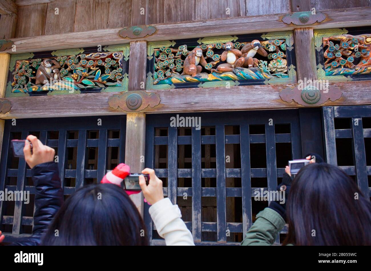 Tourist taking a photograph of Statues of the three wise monkeys embodying the proverbial principle to 'see no evil. Hear no evil. Speak no evil'. Tos Stock Photo