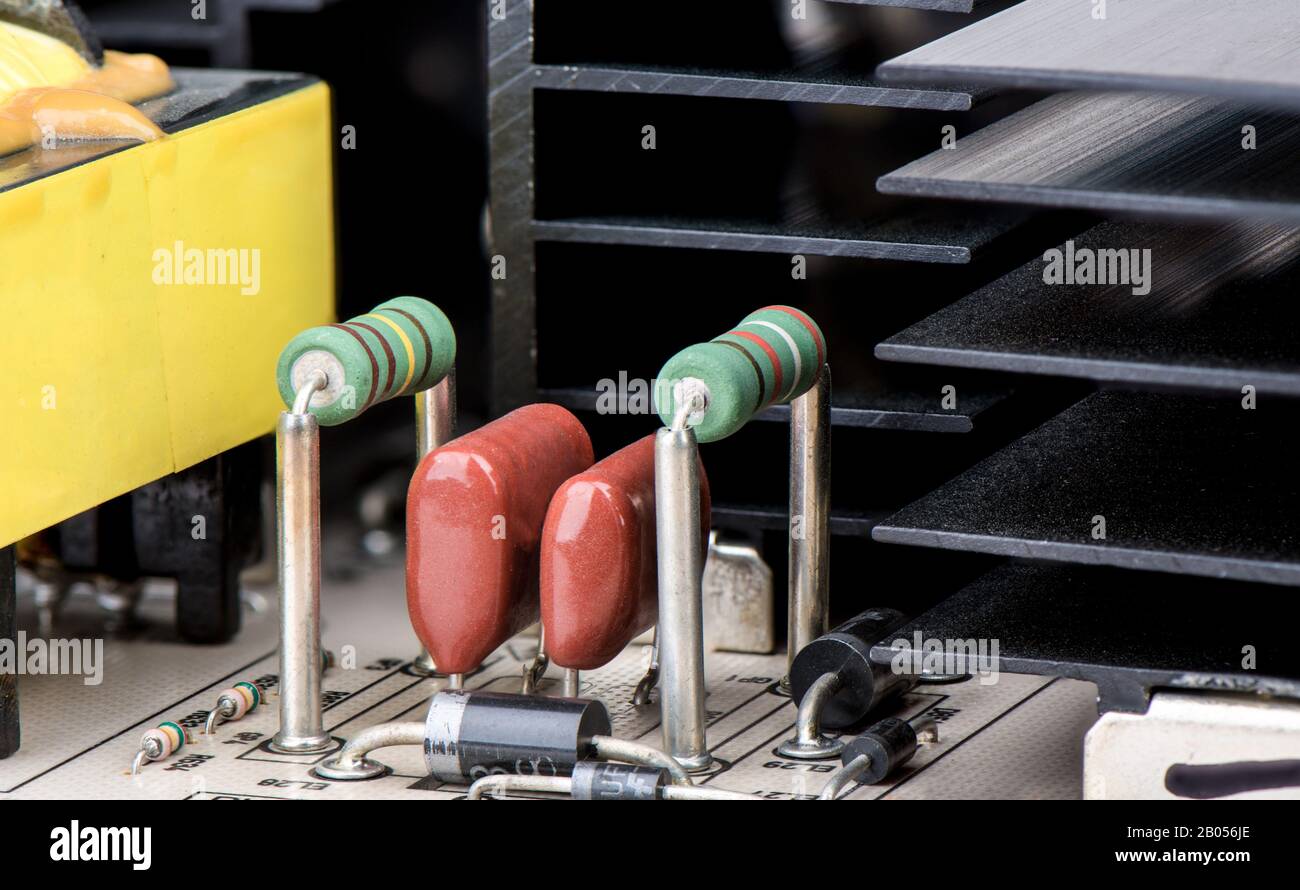 Resistors with capacitors and cooling radiator grill in the background ...