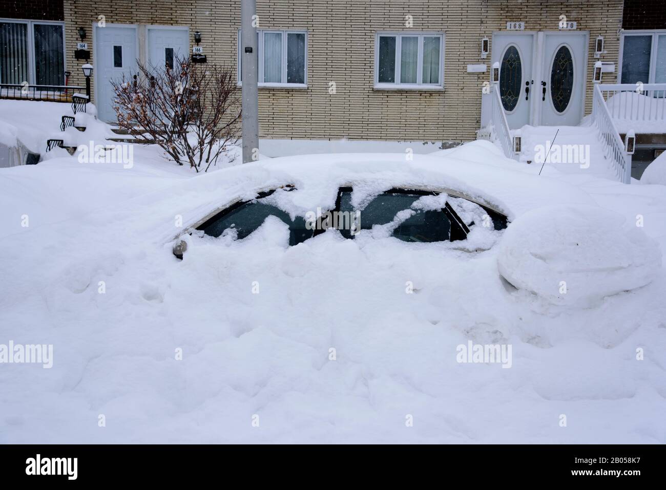 Car buried in snow after a storm, province of Quebec, Canada. Stock Photo