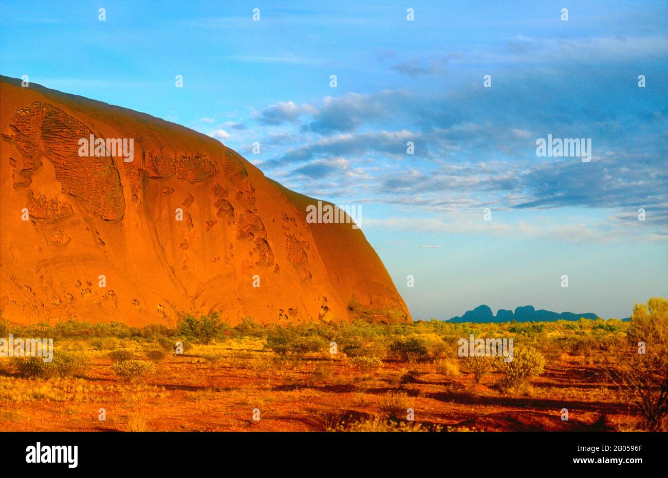 Uluru (Ayers Rock) shot at dawn, with The Olgas in the background, Uluru-Kata Tjuta National Park, Central Australia, Northern Territory Stock Photo