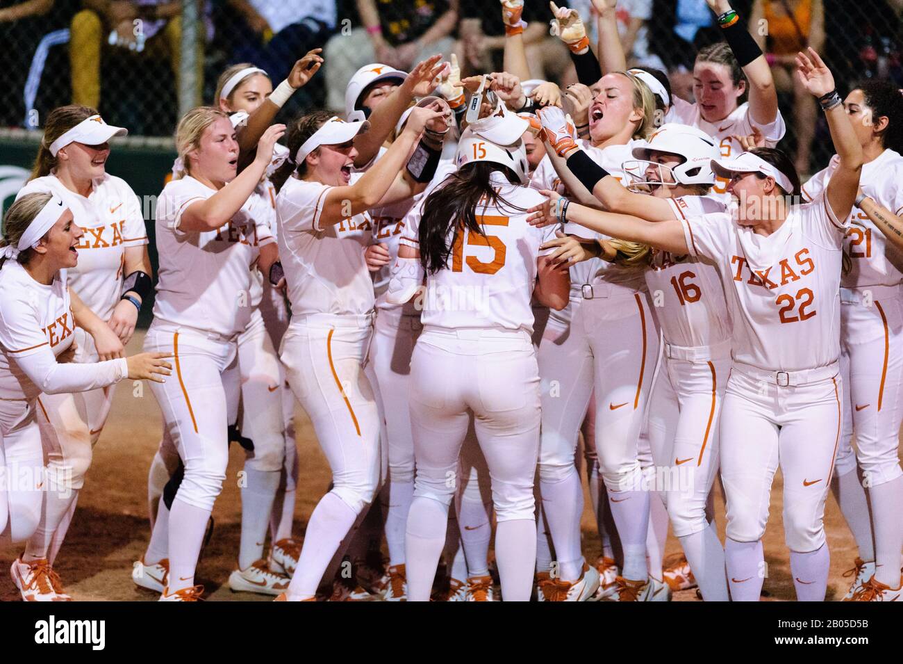 The Texas longhorns Womens Softball Team Celebrates Courtney Day's Home Run at Home Plate. Stock Photo