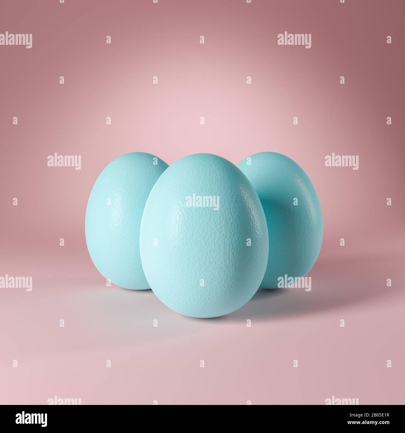 Three pastel turquoise colored easter eggs standing on a seamless pastel rose background. Copy space available. Stock Photo