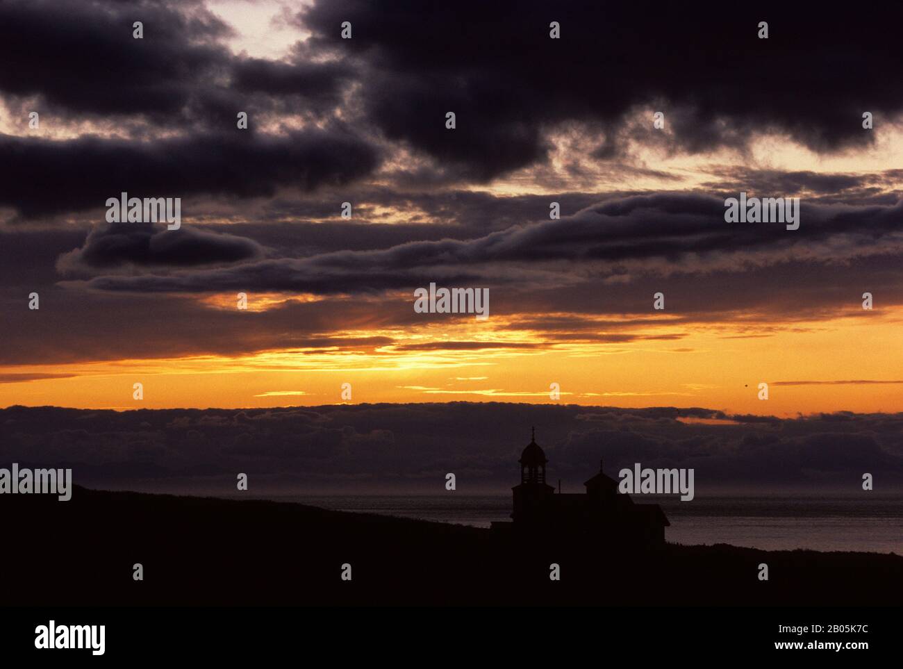 USA, ALASKA, KODIAK ISLAND, KARLUK, SILHOUETTE OF OLD RUSSIAN ORTHODOX CHURCH AT SUNSET Stock Photo