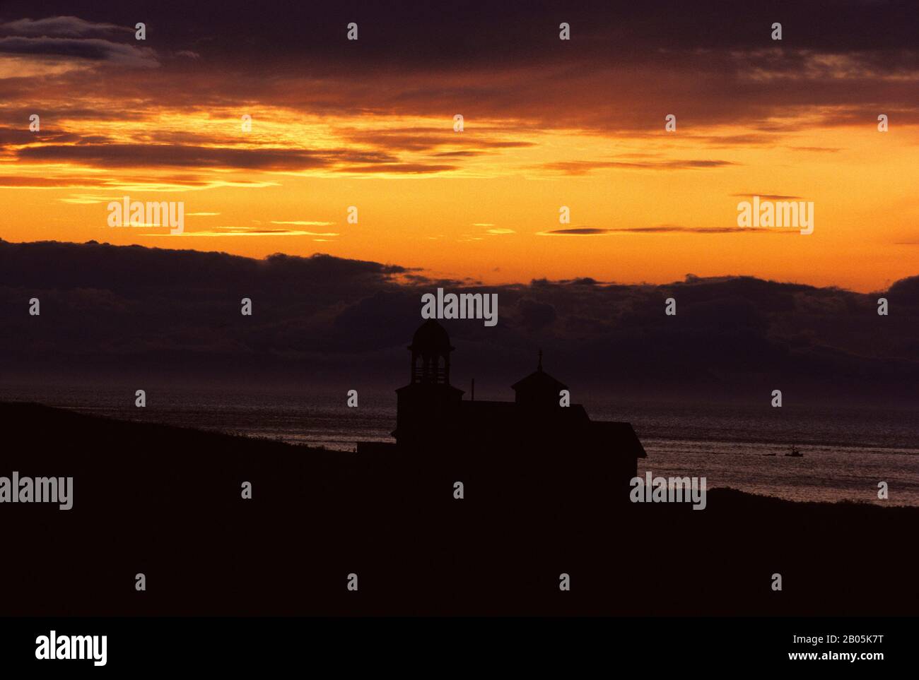 USA, ALASKA, KODIAK ISLAND, KARLUK, SILHOUETTE OF OLD RUSSIAN ORTHODOX CHURCH AT SUNSET Stock Photo