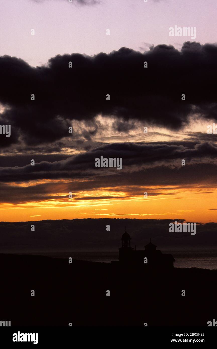 USA, ALASKA, KODIAK ISLAND, KARLUK, SILHOUETTE OF OLD RUSSIAN ORTHODOX CHURCH AT SUNSET Stock Photo