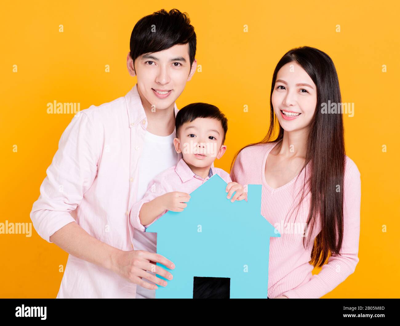 young family  hands holding paper house Stock Photo