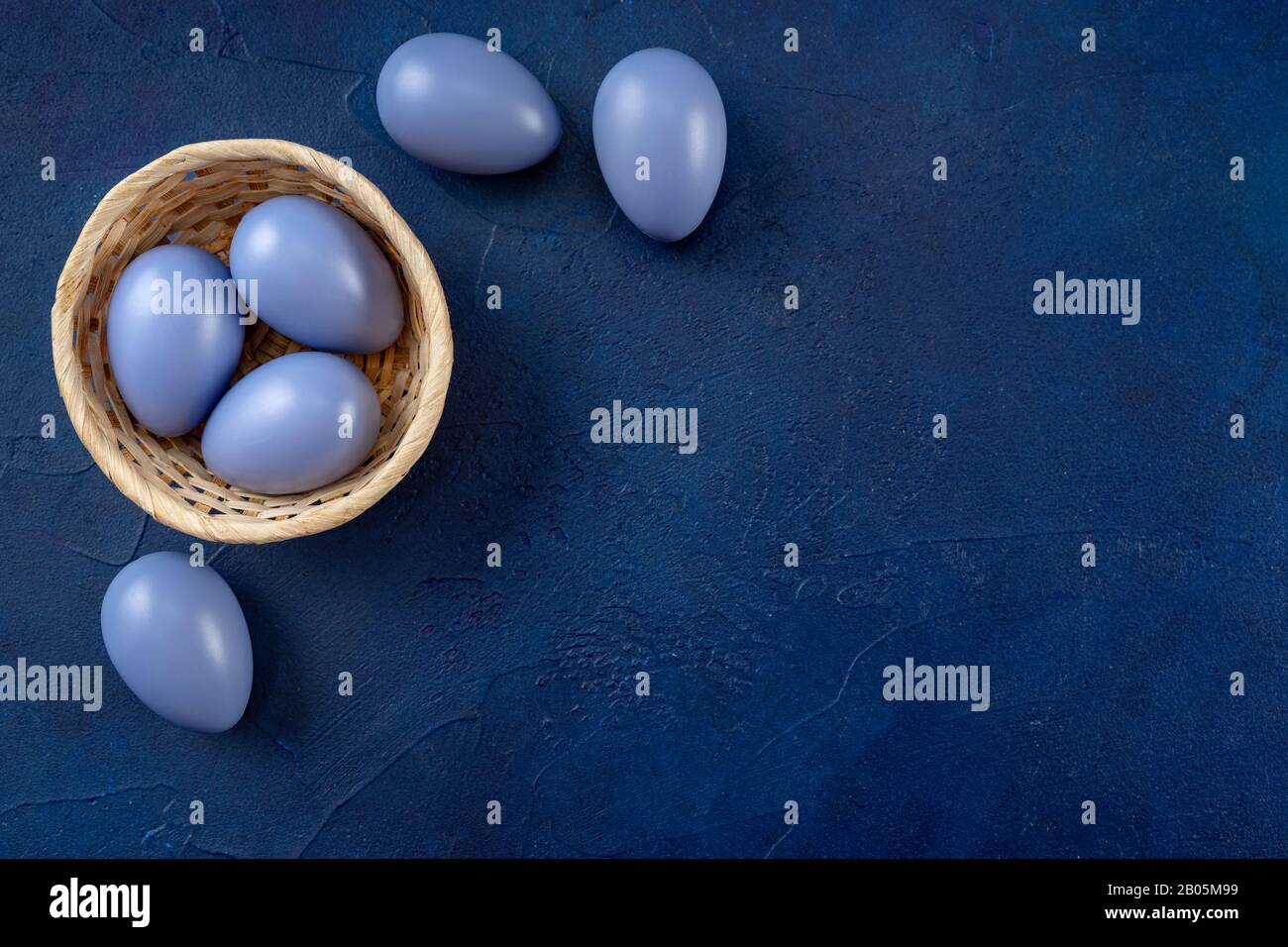 Easter composition with eggs on dark blue background Stock Photo