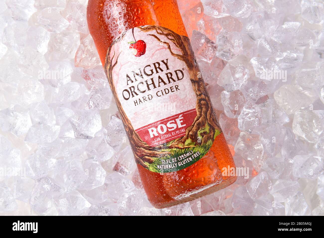 IRVINE, CALIFORNIA - OCTOBER 19, 2018: Anrgy Orchard Rose Hard Cider closeup on a bed of ice. Made with rare French Red Flesh Apples.. Stock Photo