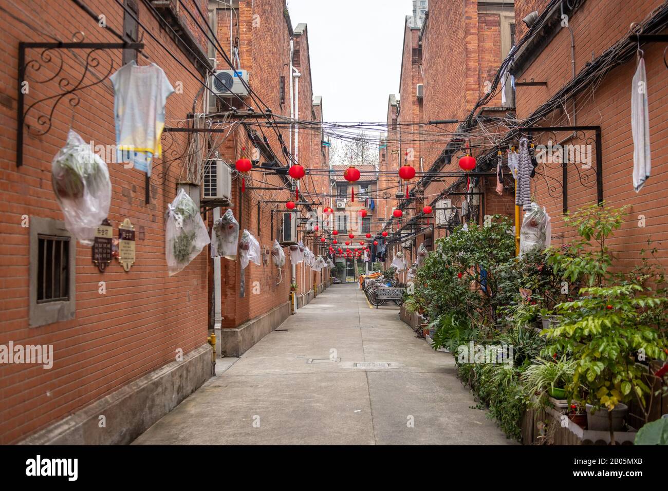 Paper lanterns celebrating Lunar New Years hanging in an empty alley , Shanghai, China Stock Photo