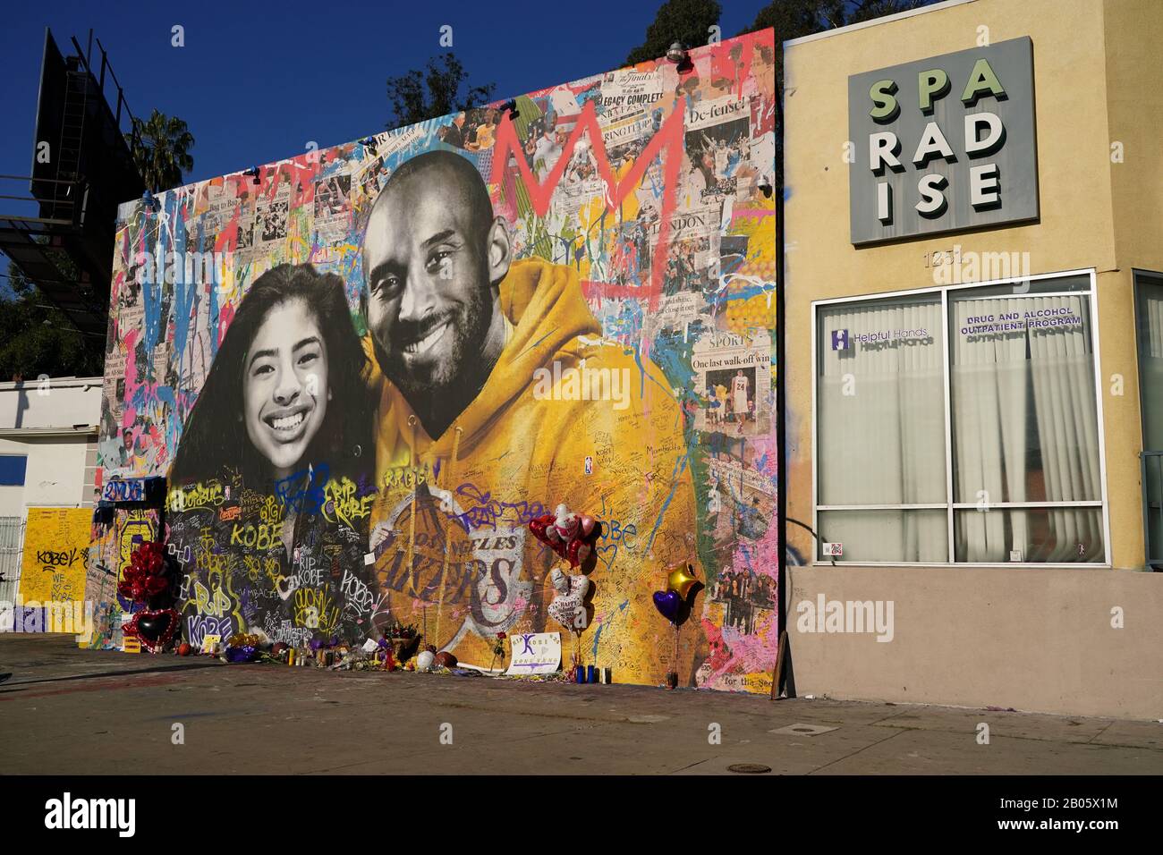 General overall view of Kobe Bryant memorial mural at Sparadise La Brea at 1251 St. La Brea Ave., Sunday, Feb 16, 2020, in Los Angeles. The mural, created street artist Thierry Guetta aka Mr. Brainwash, showcases Bryant and his daughter Gigi Bryant (Gianna Bryant), with the former basketball player wearing a Lakers sweatshirt against a colorful background and newspaper images of Bryant during his NBA years, on the front. There is another image of Bryant in his purple Lakers uniform with a quote of his written next to him on the side of the building. This mural also pays tribute to the other se Stock Photo