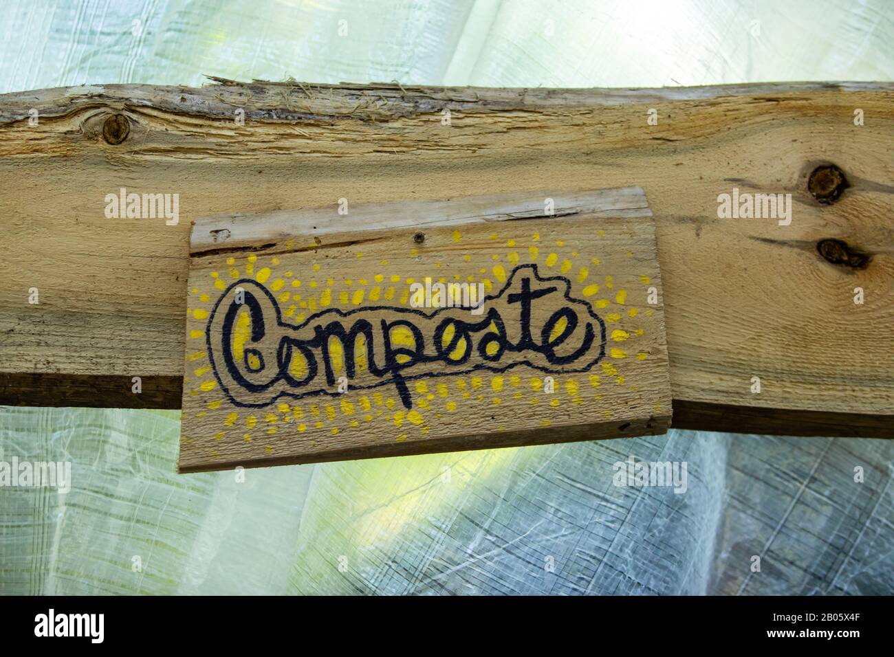 A close up view of a rustic handwritten wood sign, french word 