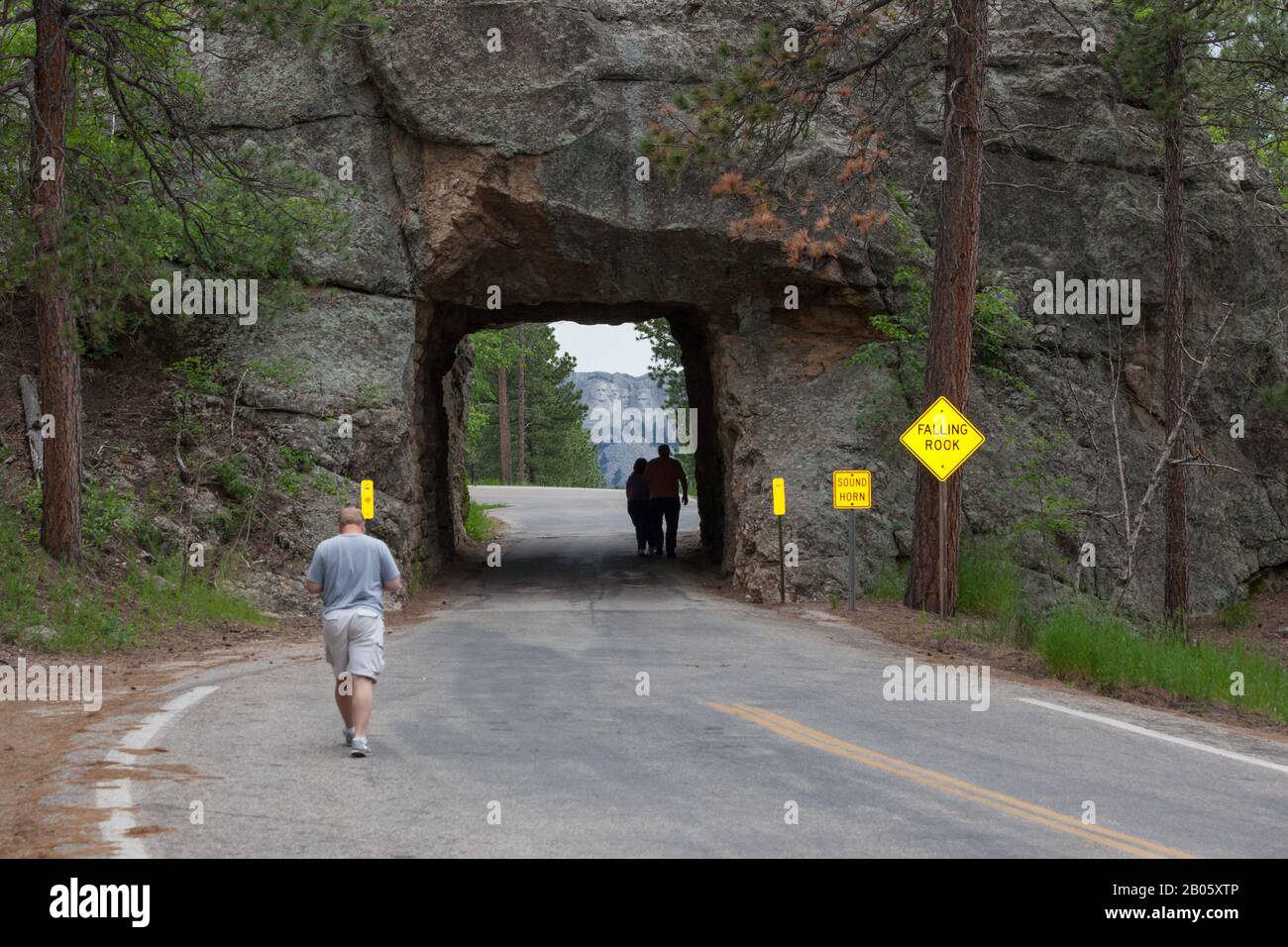 KEYSTONE, SOUTH DAKOTA - June 27, 2014: Tourists walk through the Scovel Johnson tunnel on Iron Mountain Road with views of Mount Rushmore in Keystone Stock Photo