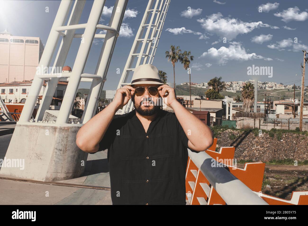 Handsome Mexican Chubby man with fedora style hat putting on his aviator glasses Stock Photo Alamy