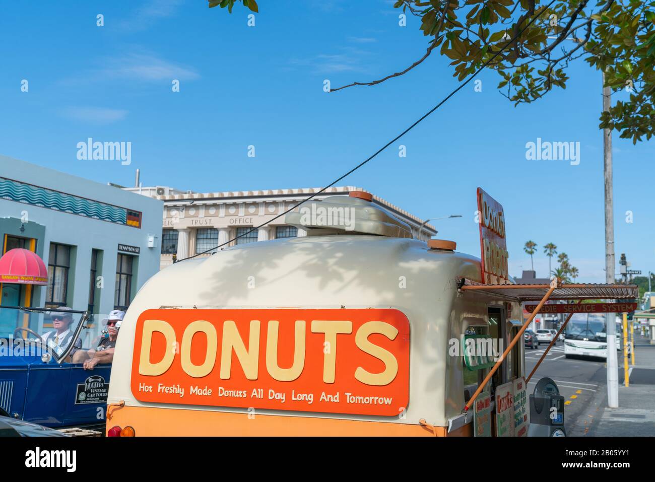 Napier - New Zealand - February 16 2020; Donuts food cart opens in Napier street with large orange colored sign. Stock Photo
