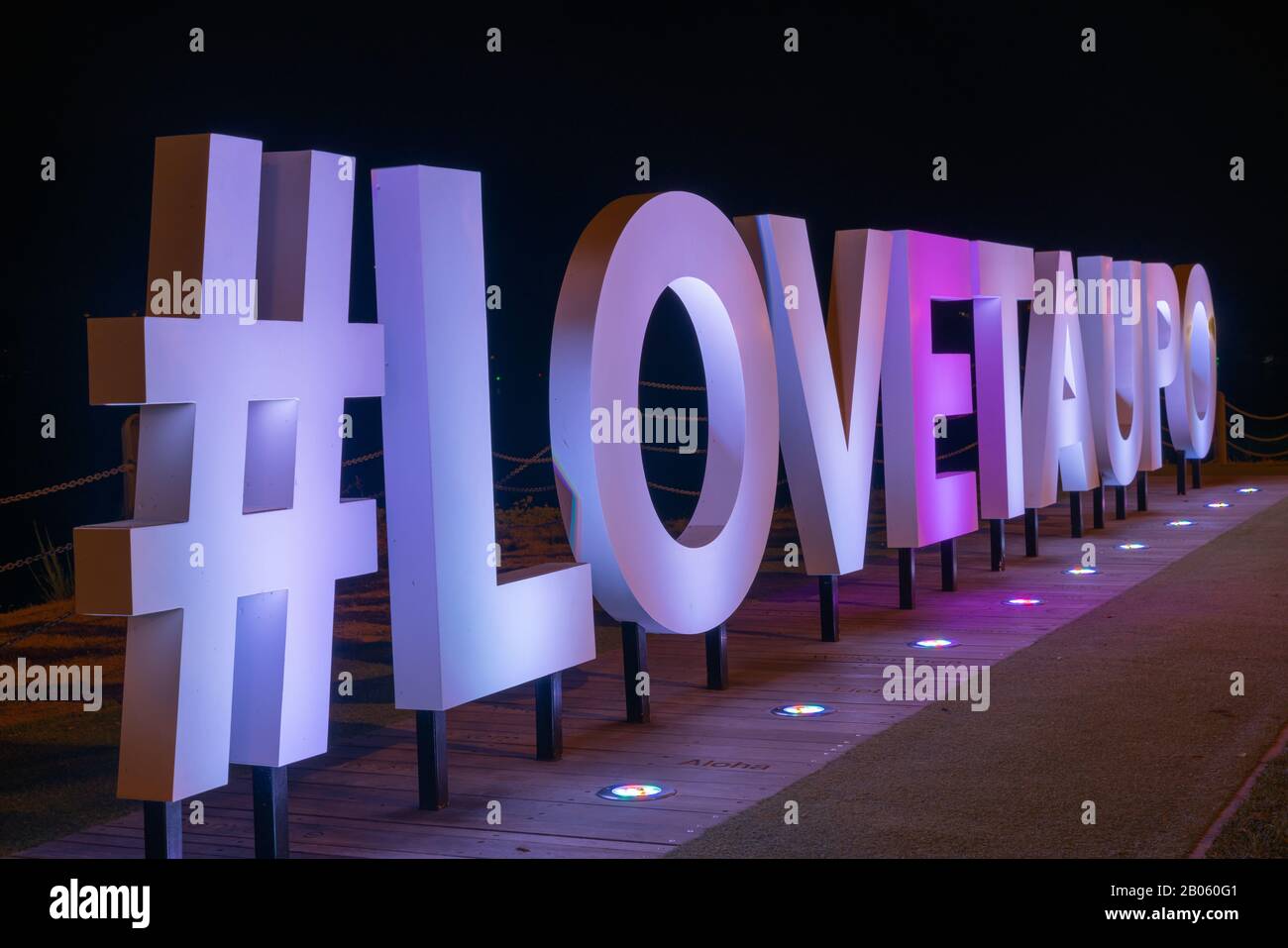 Taupo New Zealand  - February 14 2020; Love Taupo bright white tourism promotional sign at night Stock Photo