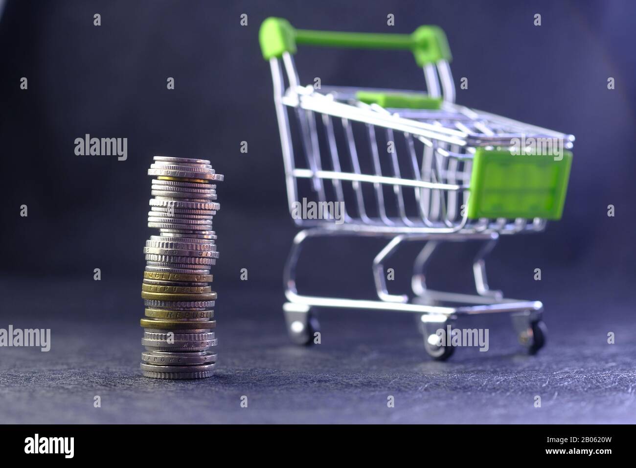 stack of coins and shopping cart on table  Stock Photo