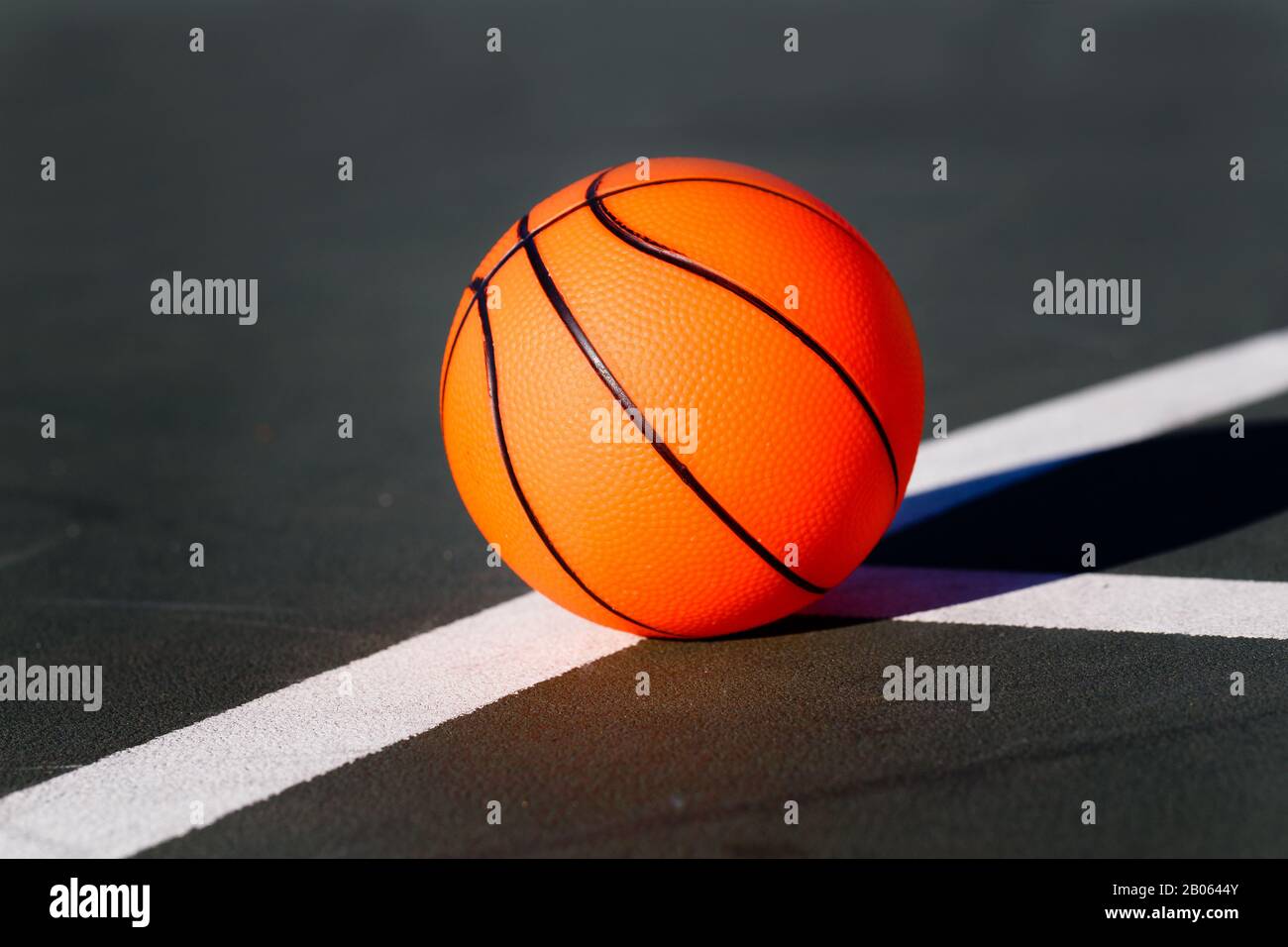 Kid Child Basketball Toy on Black Asphalt Free Throw Line Stock Photo