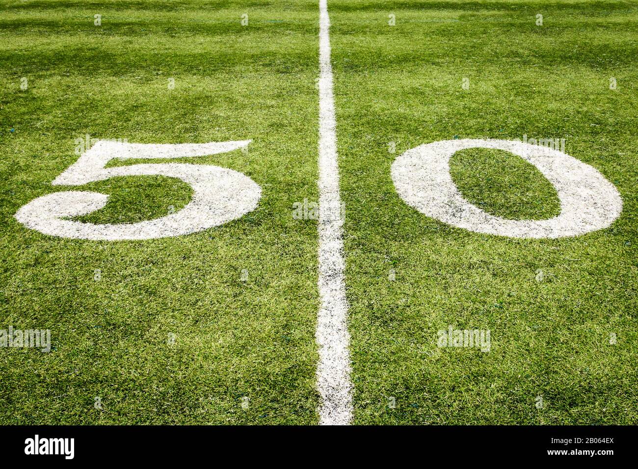 Football Field 50 Yard Line on the Grass with Artificial Turf Stock Photo