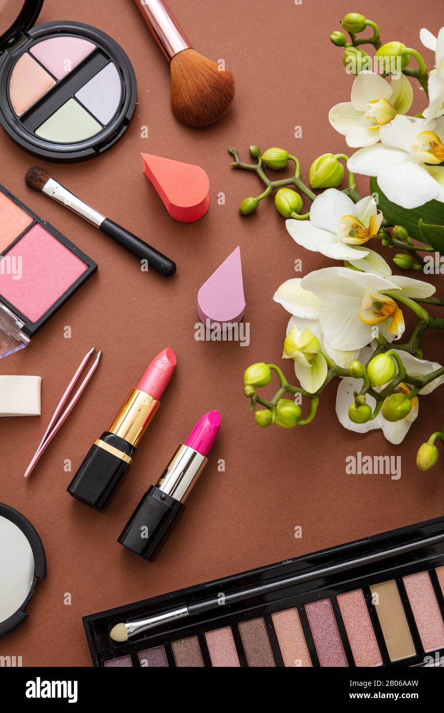 Makeup natural cosmetic products against brown color background. Make up  female accessories, vertical, top view Stock Photo - Alamy