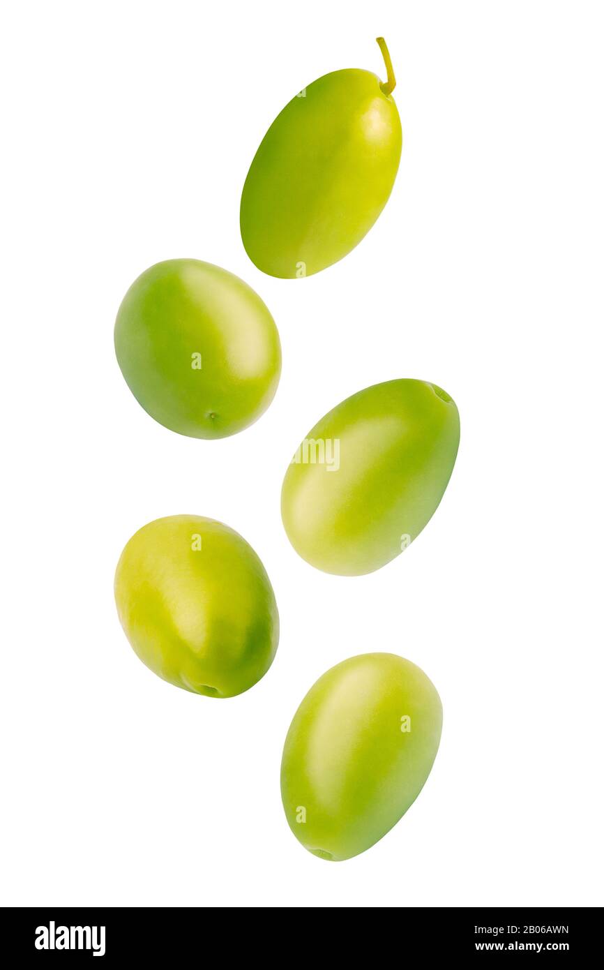 Falling green pickled olives isolated on white background. Stock Photo
