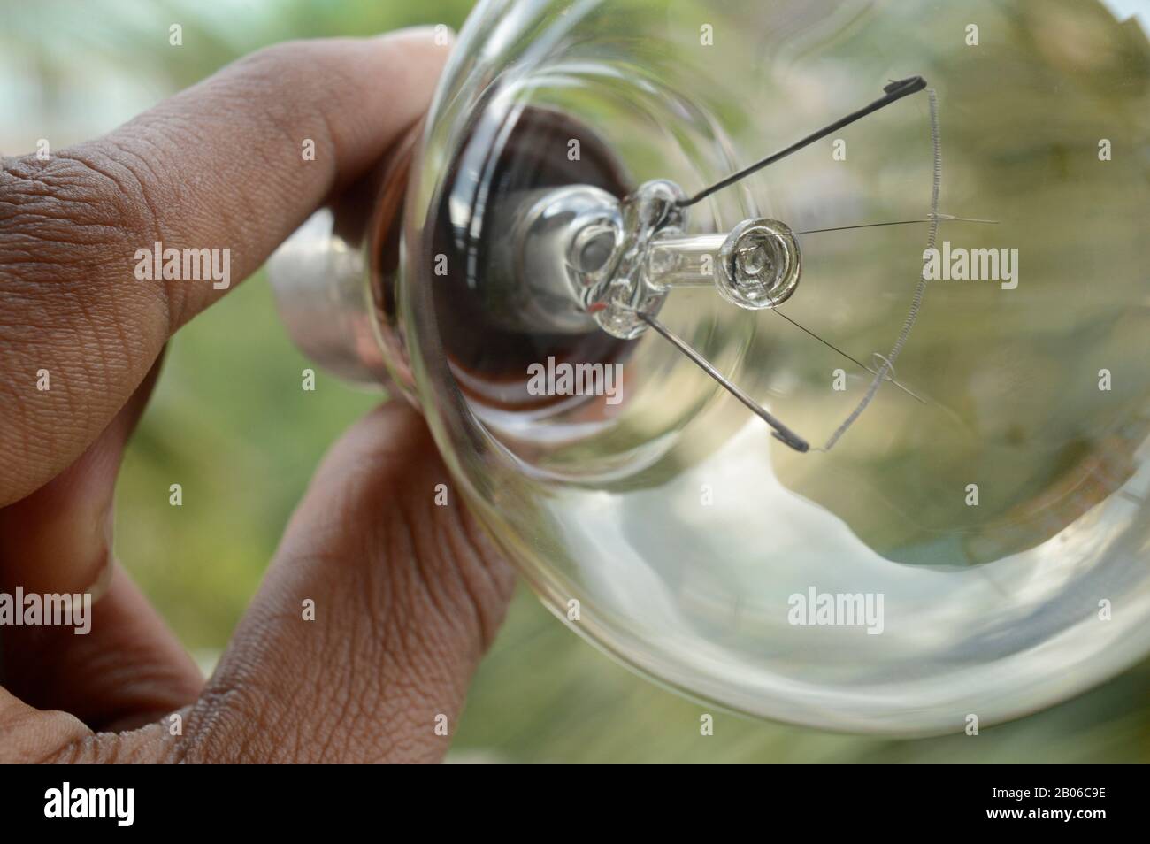 Hand holding a Tungsten Bulb Stock Photo
