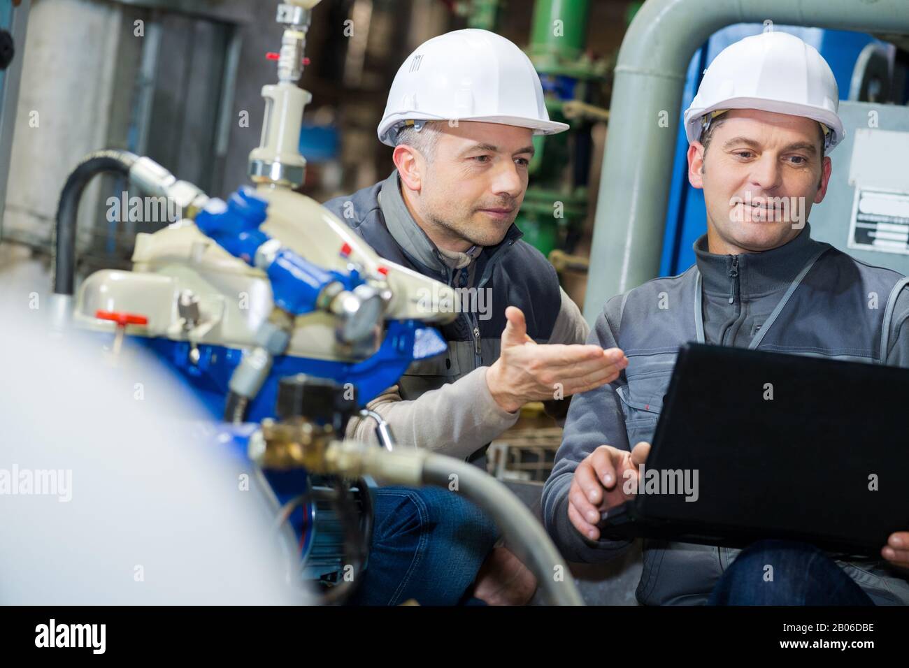 engineers discussing maintenance of a petrochemical plant Stock Photo