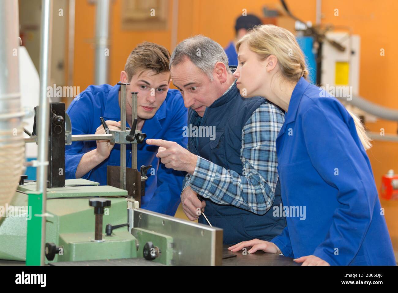 engineer training apprentices on machine Stock Photo