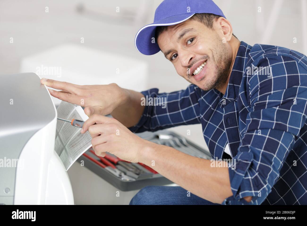 trying to repair the air conditioning unit Stock Photo Alamy