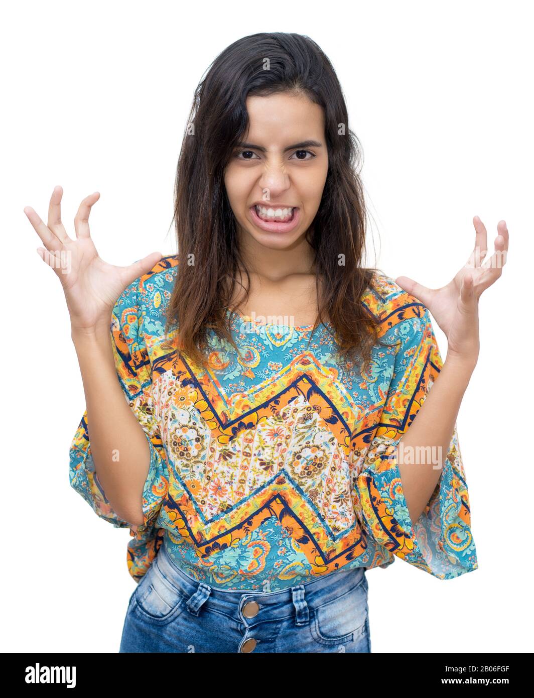 Angry mexican young adult woman with long dark hair on isolated white background for cut out Stock Photo