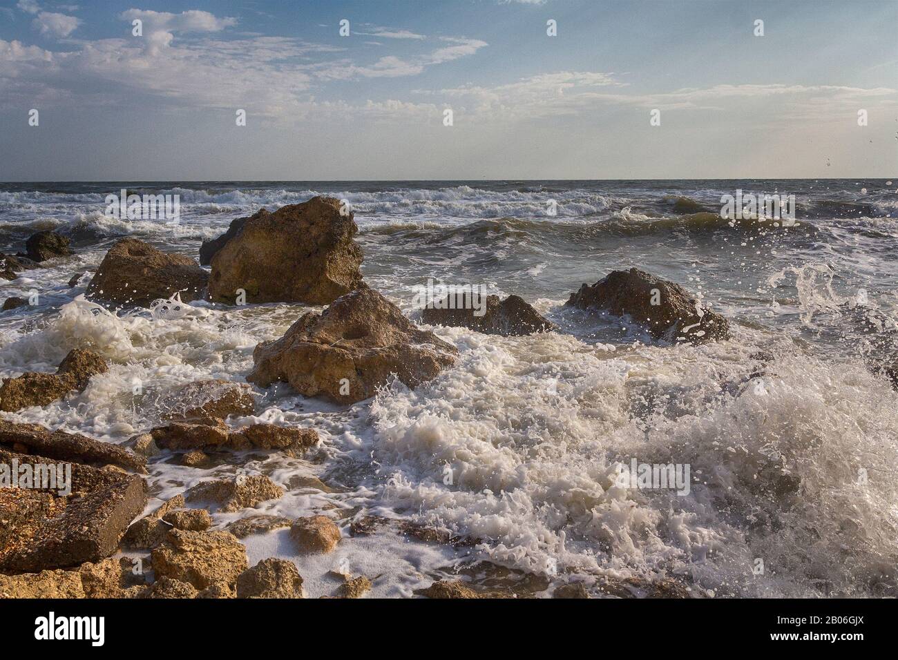 Waves stumble across rocks on the coast. Nature Stock Photo