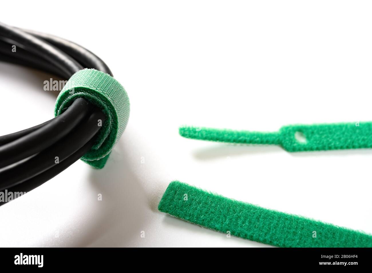 green velcro cable tie and cable on white Stock Photo