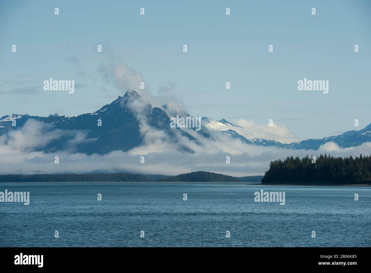 View of mountains with fog clearing at Sitakaday Narrows near Bartlett Cove, Glacier Bay National Park, Alaska, USA Stock Photo