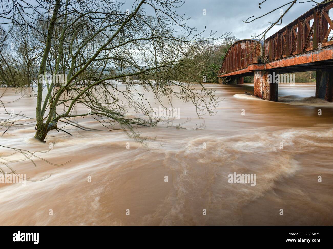 The river Wye rushes under the Duke of Beaufort Bridge as it reaches its highest ever recorded level during heavy rainfall in February 2020. Stock Photo