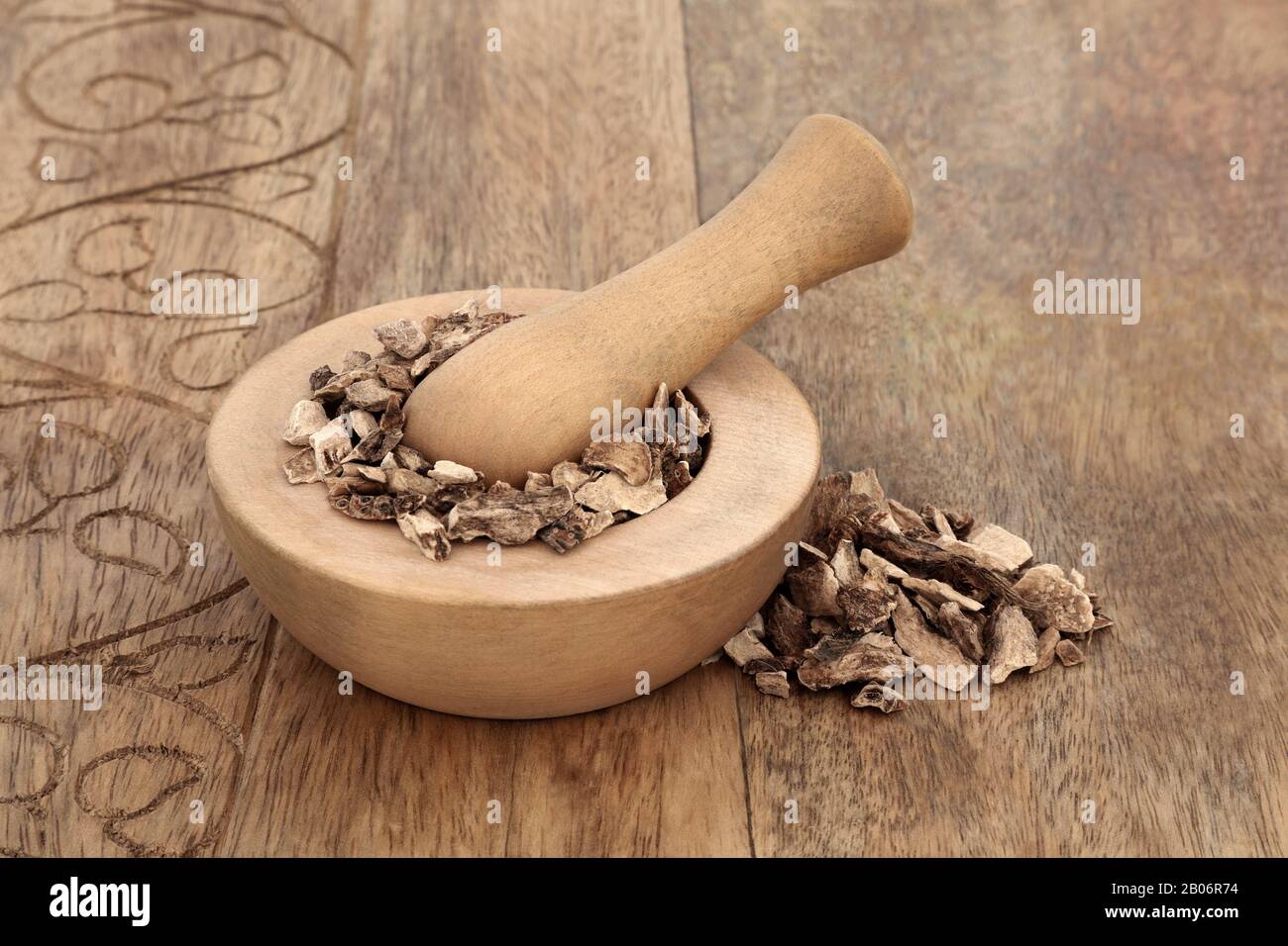 Calamus herb root in a mortar with pestle used in herbal medicine to treat ulcers, upset stomach and inflammation, diarrhoea & flatulence. Stock Photo