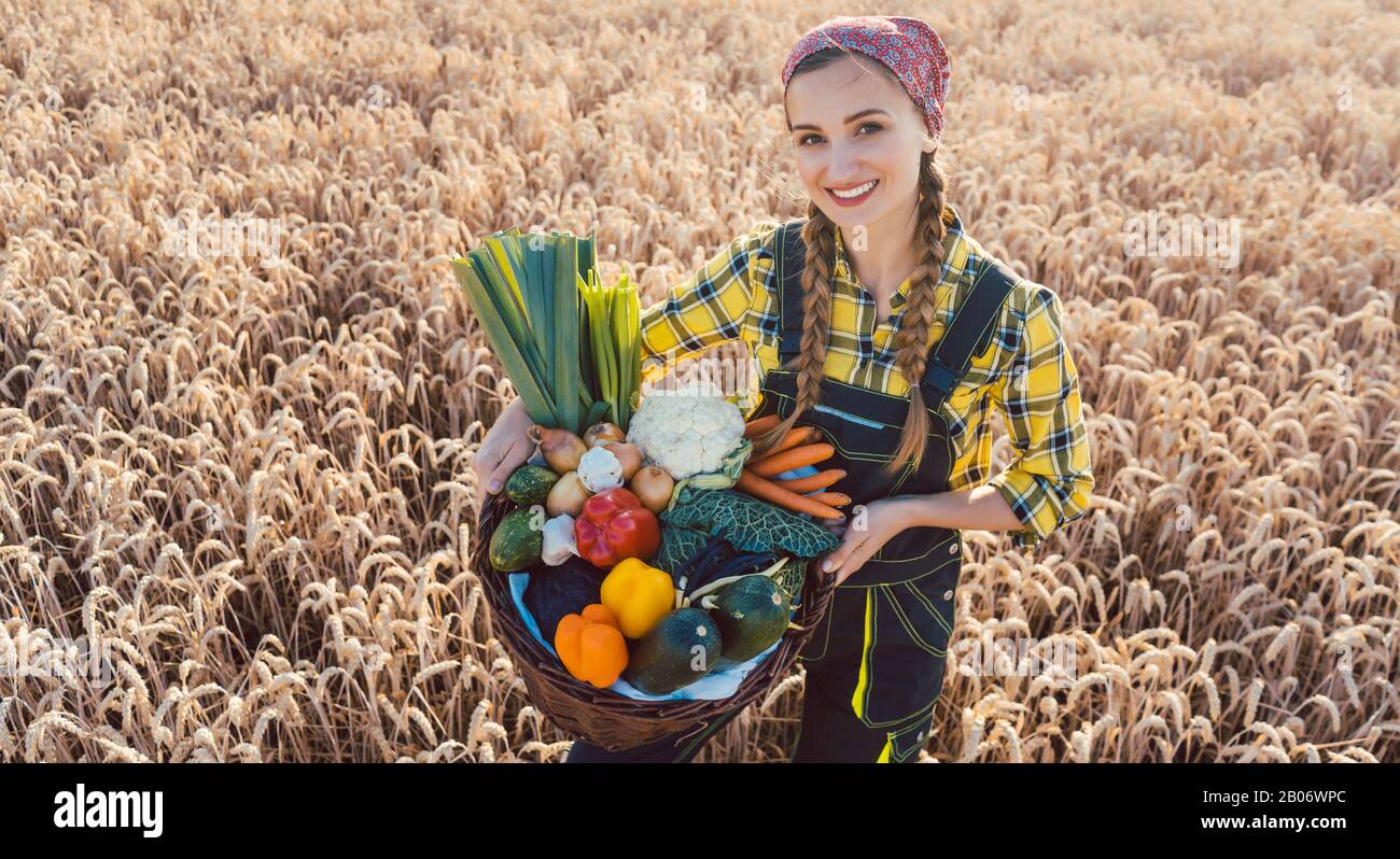 Farmer woman offering healthy vegetables Stock Photo - Alamy