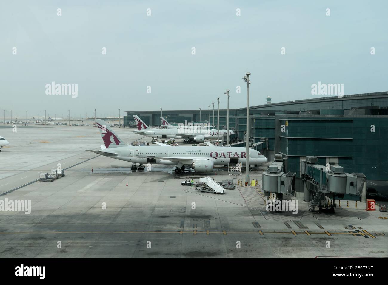 Doha / Qatar – February 18, 2020: Qatar Airlines planes on the stand at Hamad International Airport, Doha, Qatar Stock Photo