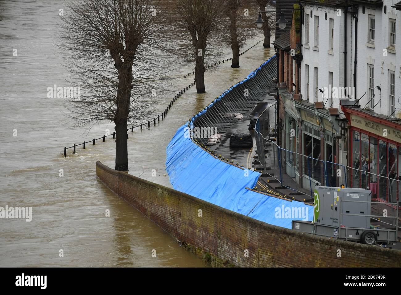 Temporary flood barriers hold back the river Severn in Ironbridge ...