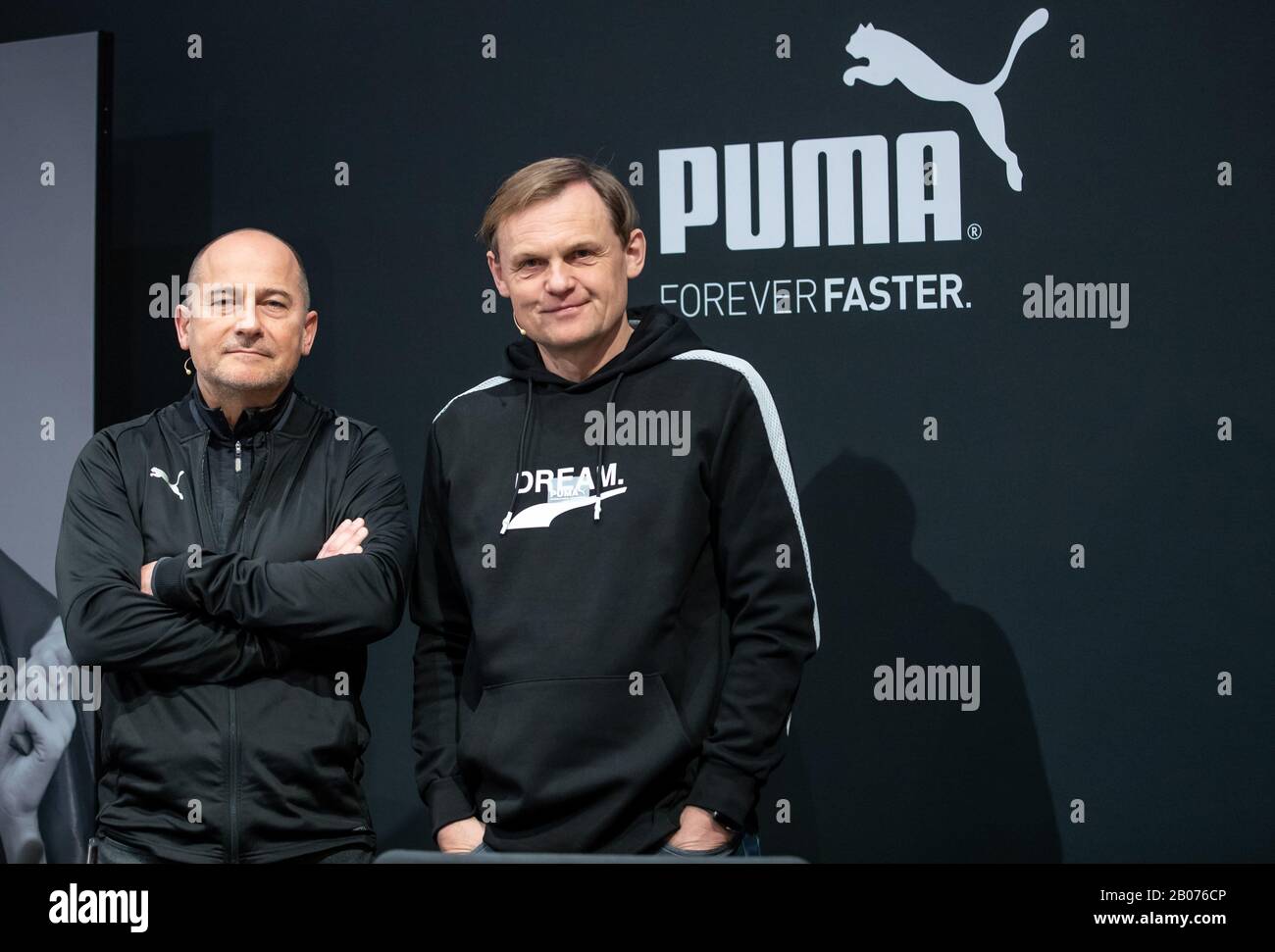 19 February 2020, Bavaria, Herzogenaurach: Björn Gulden (r), Chairman and  Managing Director of the sporting goods manufacturer Puma SE, and Michael  Lämmermann, Puma's CFO, are standing in front of the company logo