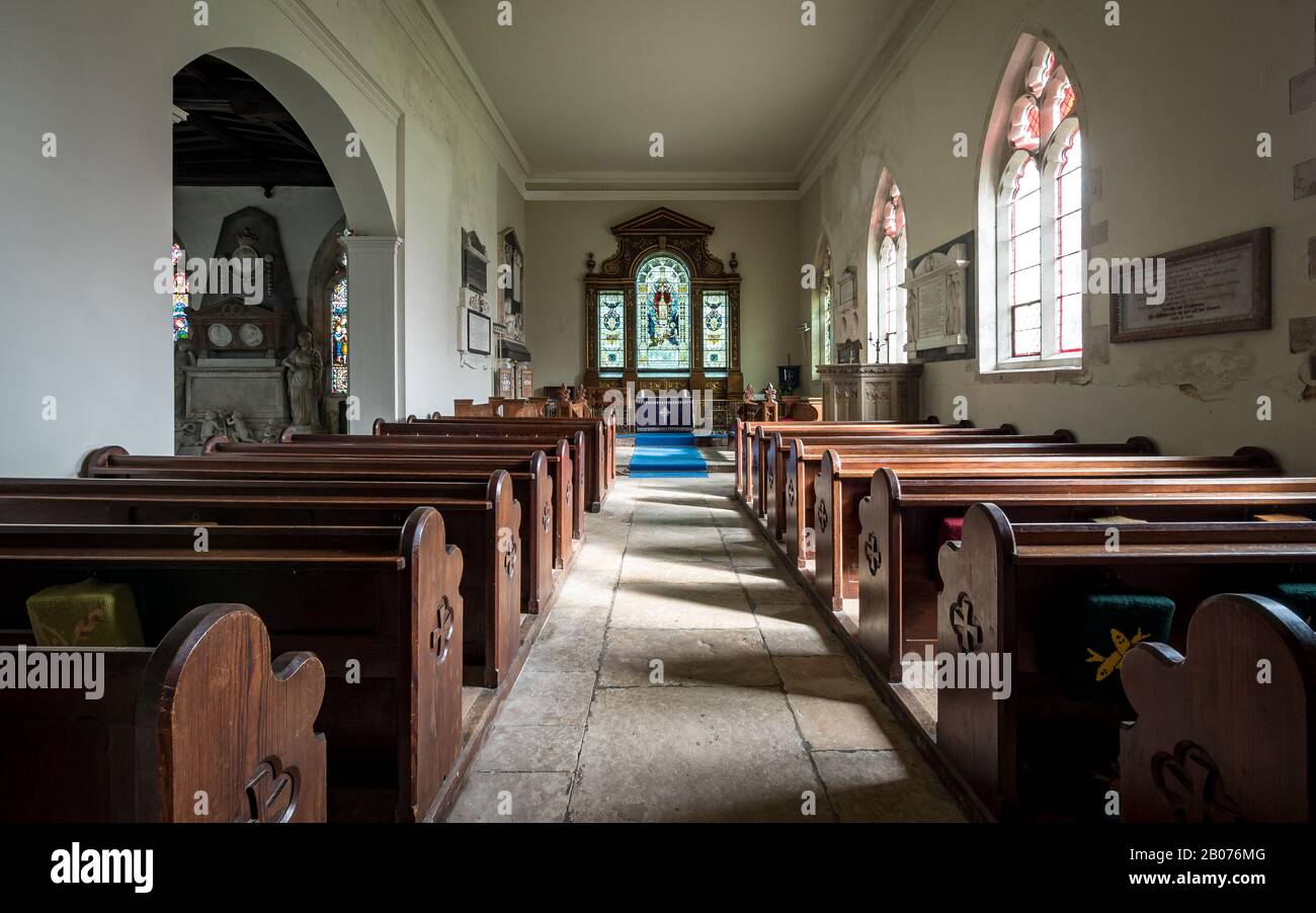 St. Andrew's Parish Church, Wimpole, Cambridgeshire, UK. The interior of an old rural English church with its original wooden pews and altar. Stock Photo