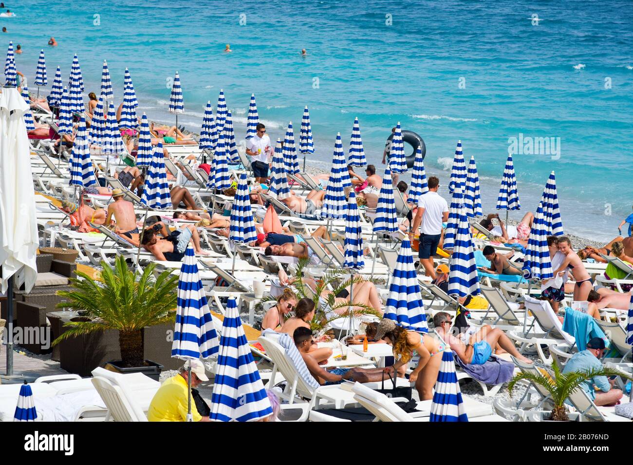 NICE, FRANCE JUNE 4, 2017 People sunbathing on the beach in Nice, in