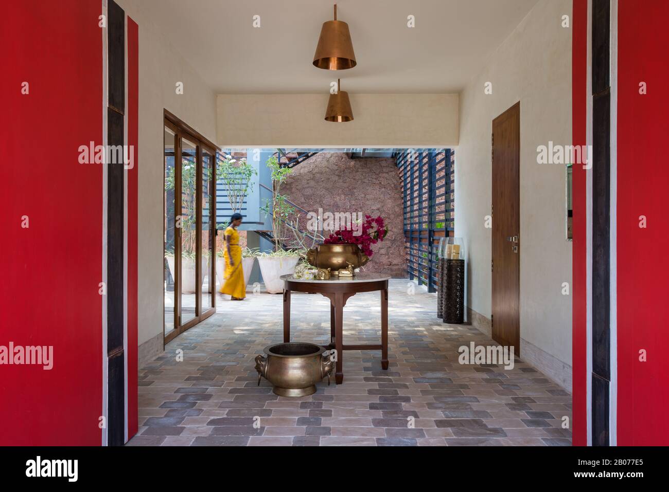 Flowers on table in tiled hallway Stock Photo