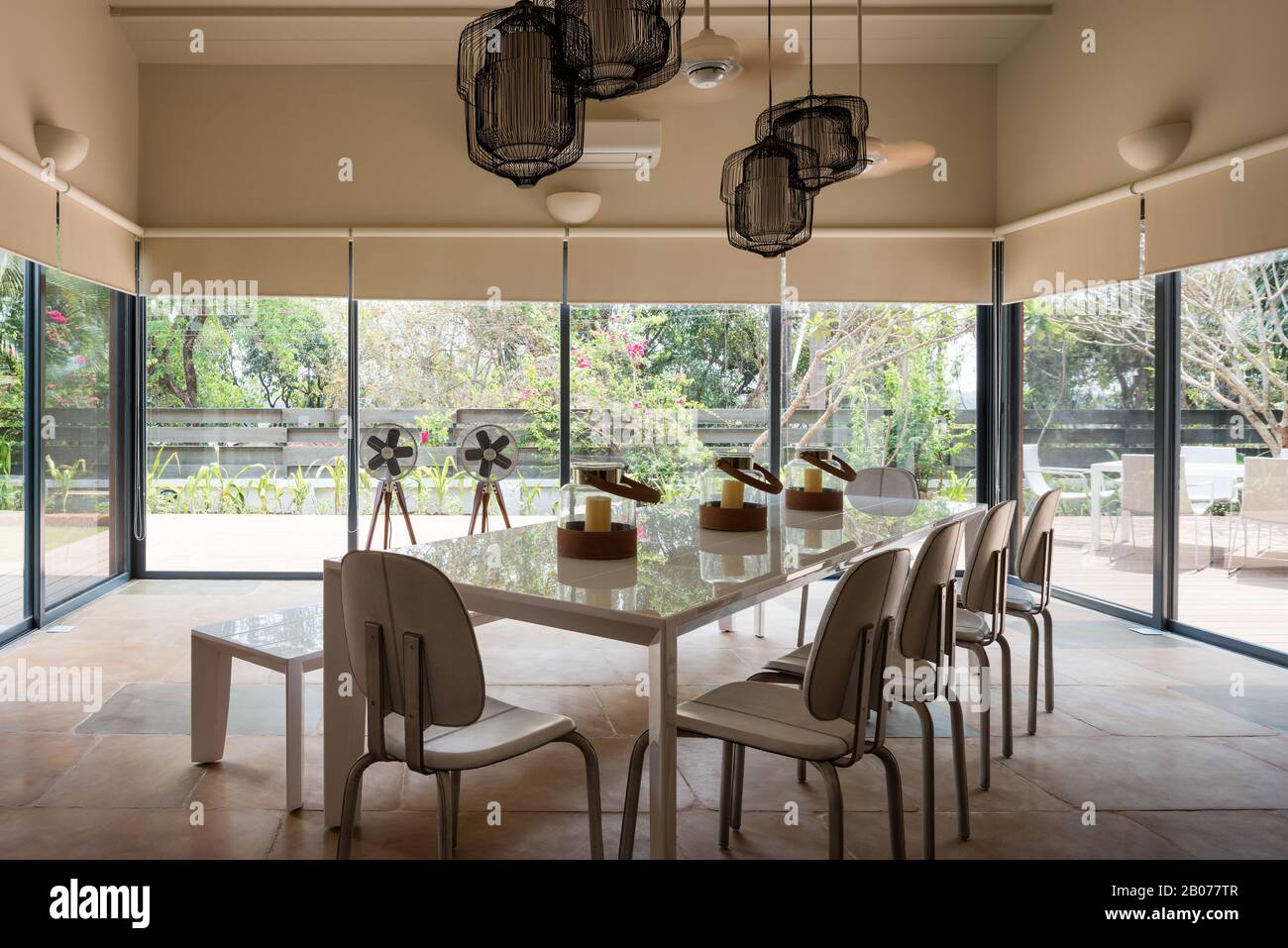 Modern dining room with pendant lights Stock Photo - Alamy