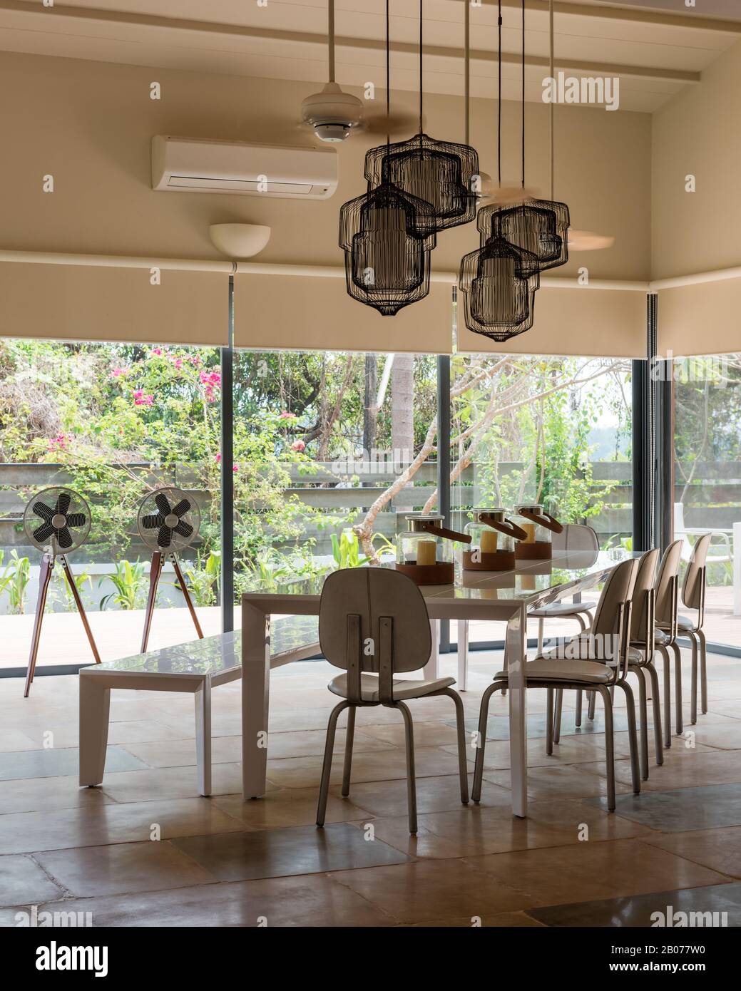 Modern dining room with pendant lights Stock Photo - Alamy