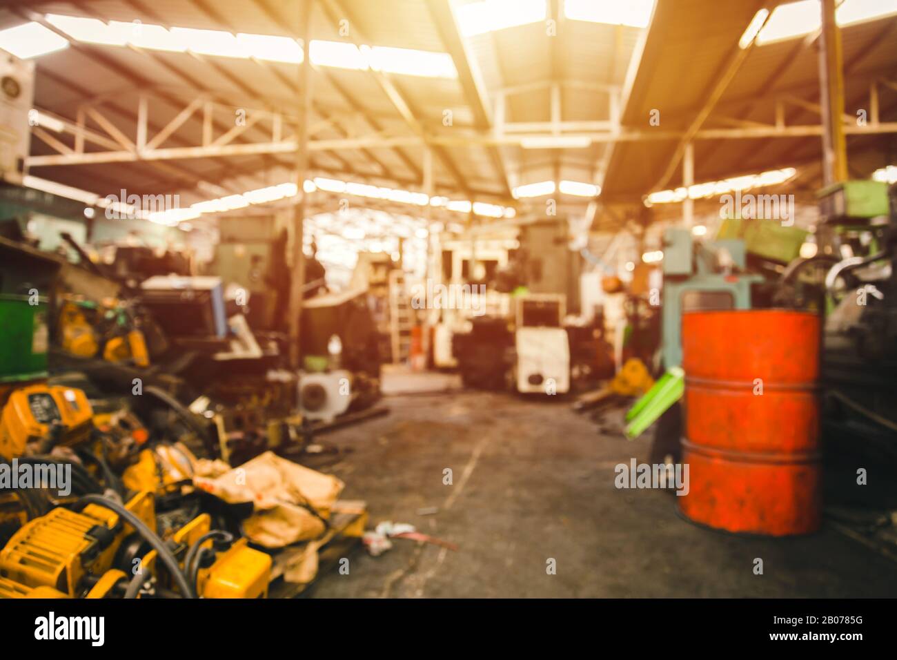 Blur used machinery workshop garage or heavy machine junkyard warehouse for background. Stock Photo