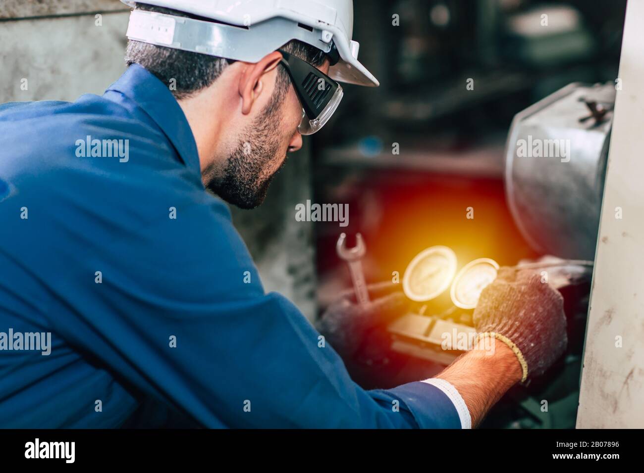 Machine repair fixing pressure gauge of machine in factory need to service and check. Stock Photo
