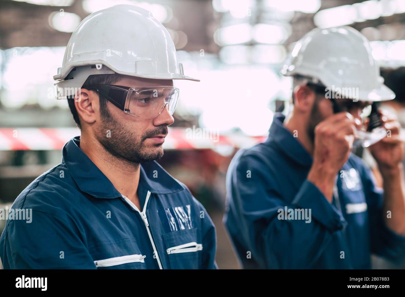Head of engineer, worker leader portrait self confidence and professional look wearing safty glasses and white helmet. Stock Photo