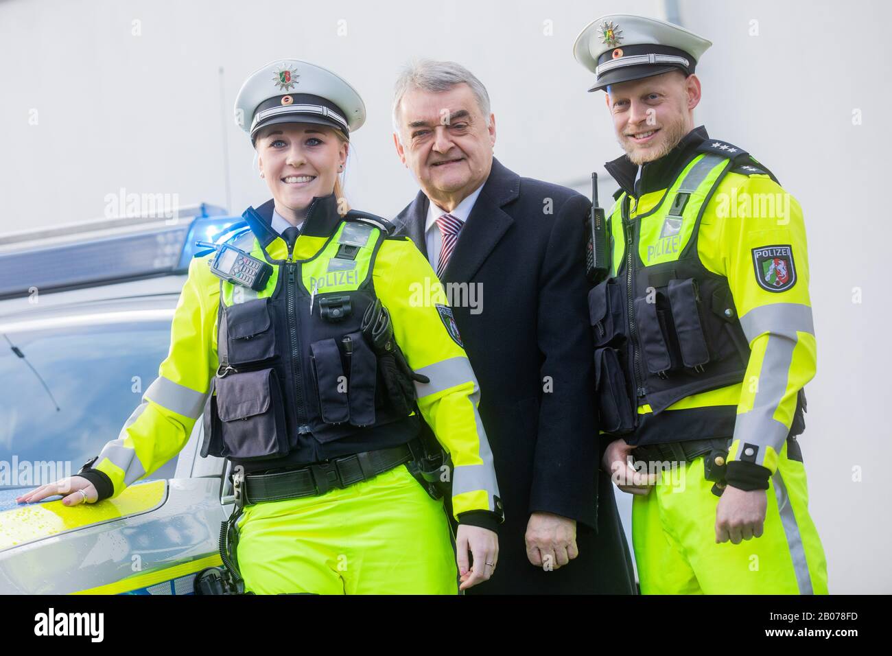 19 February 2020, North Rhine-Westphalia, Mönchengladbach: Police officers  Pia Caspers (l) and Oliver Kloß together with Herbert Reul (CDU), Minister  of the Interior of North Rhine-Westphalia, present the new uniforms in  signal