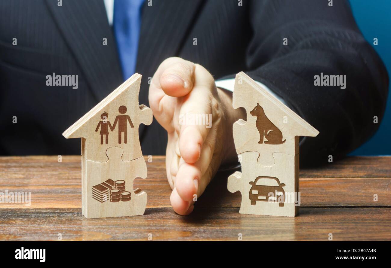 Puzzle house is divided into two equal parts by a lawyer in a divorce process. Protection of rights. Conflict resolution. Court, justice. Disputes ove Stock Photo