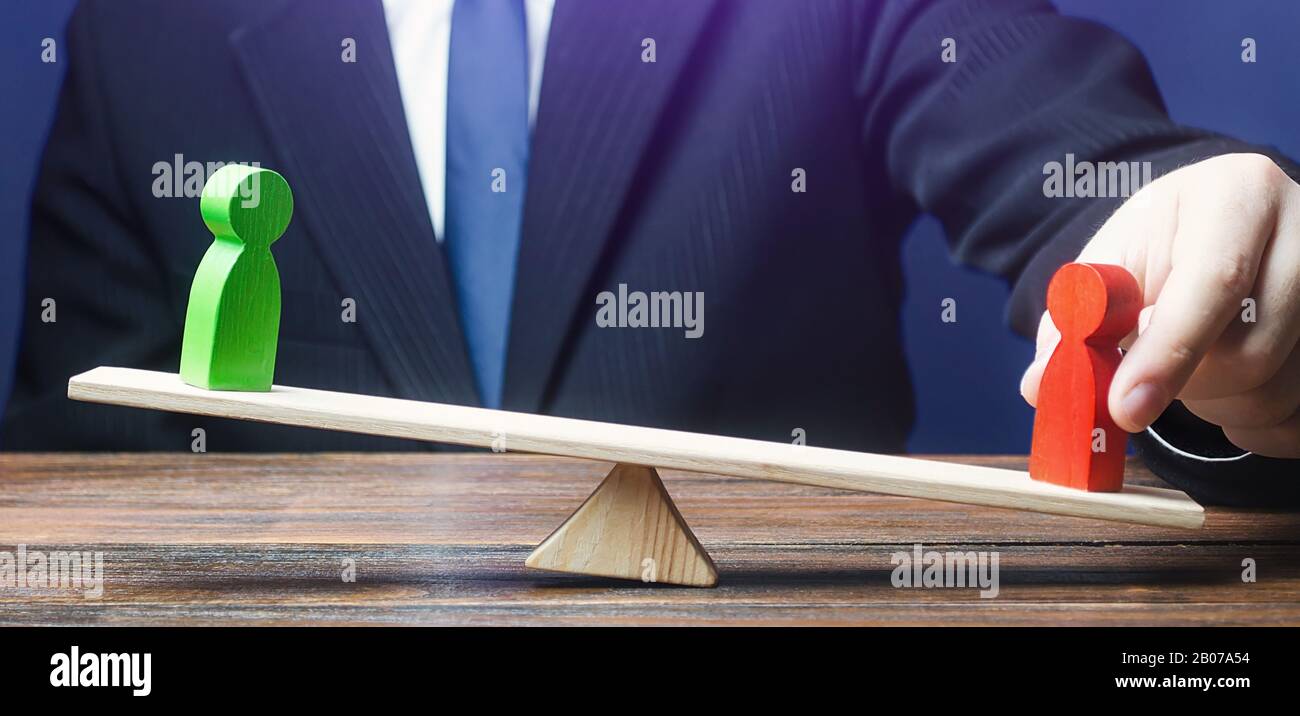 Man opposes green figure to red opponent on scales. Support enemy gain, Intrigue political struggle. Give an advantage, change balance of power, chang Stock Photo