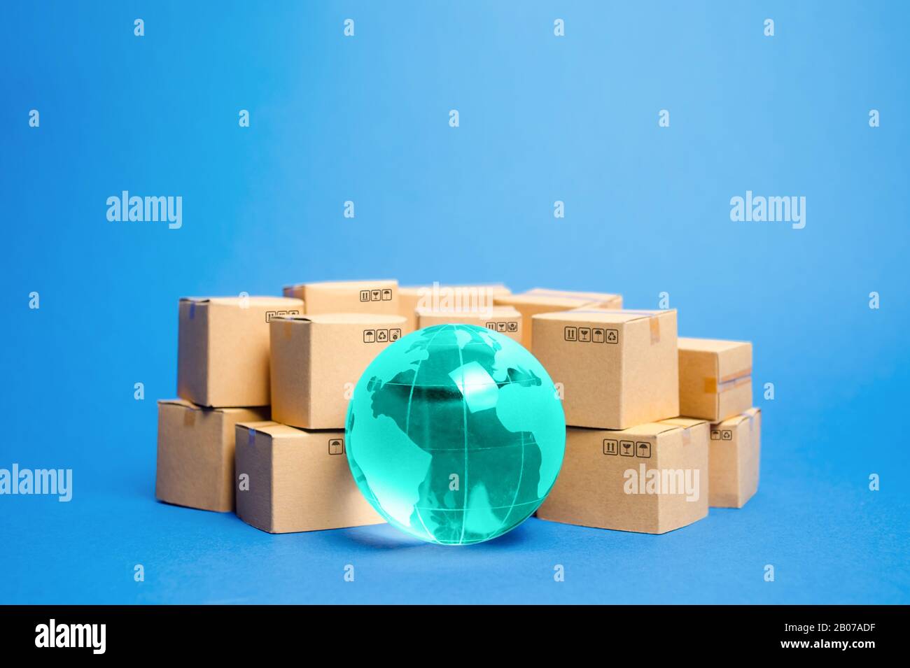 Earth globe is surrounded by boxes. Global business and international transportation of goods products. Shipping freight, world trade and economics. D Stock Photo
